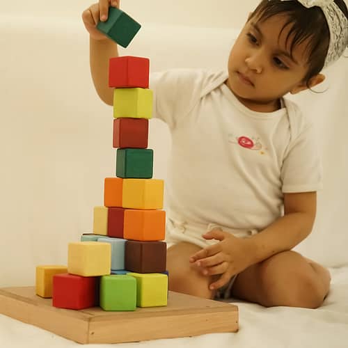Cute Girl Play with Wooden Rainbow Blocks Set Toys