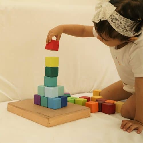 baby playing with wood square blocks set toy
