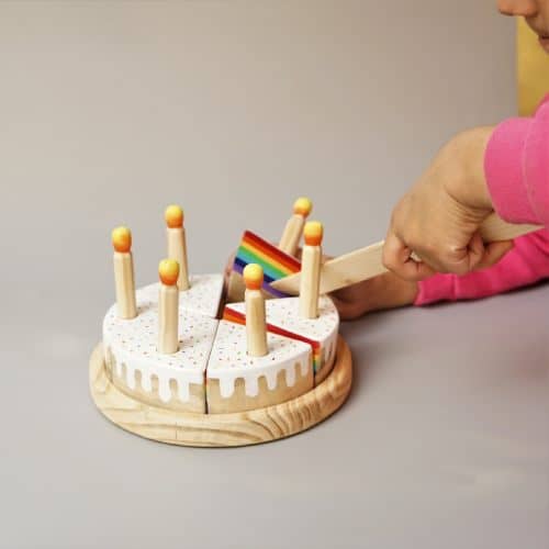 Hand Holding Knife and Cutting Wooden Cake Toy