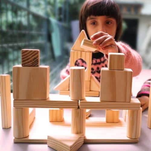 baby playing with wooden block set toy